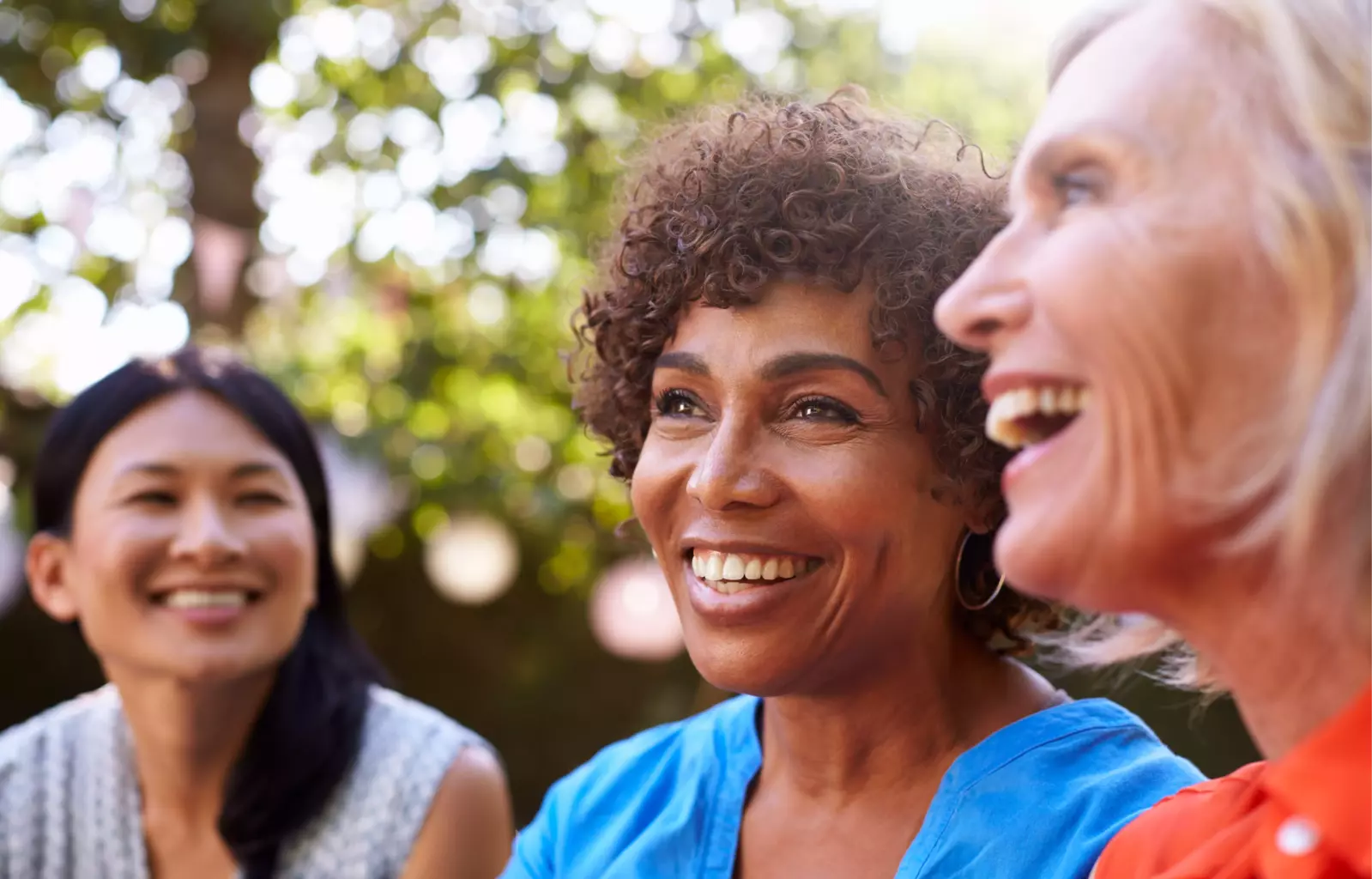 three women laughing together