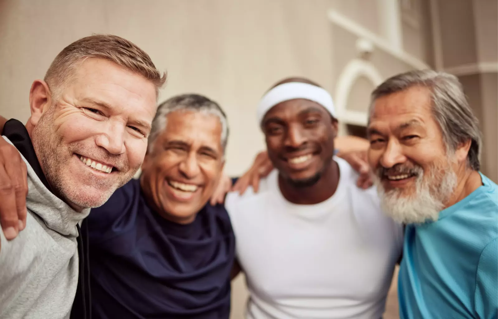 group of men smiling in a gym