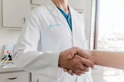 doctor shaking hands with patient