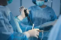 Image of a urological laparoscopic surgery, nurses and surgeon in blue surgical scrubs