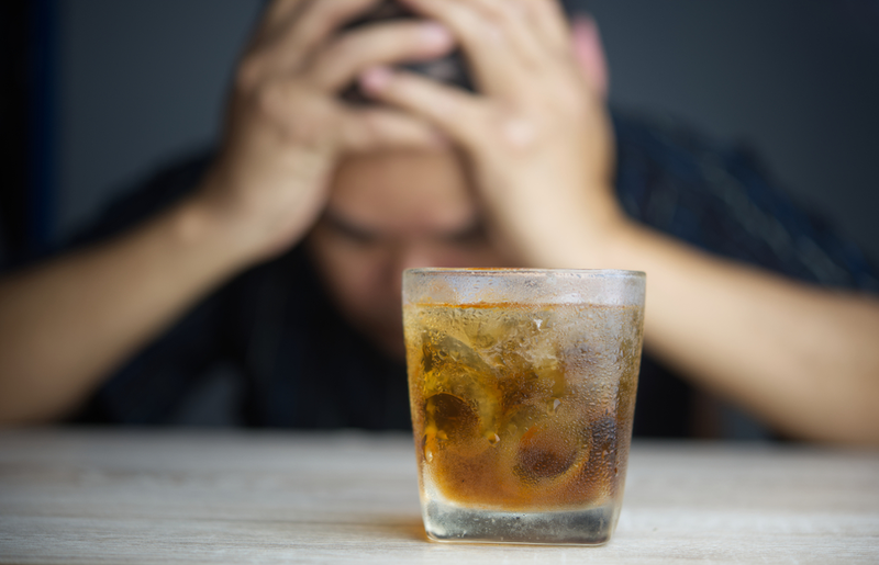 man sitting in front of drink