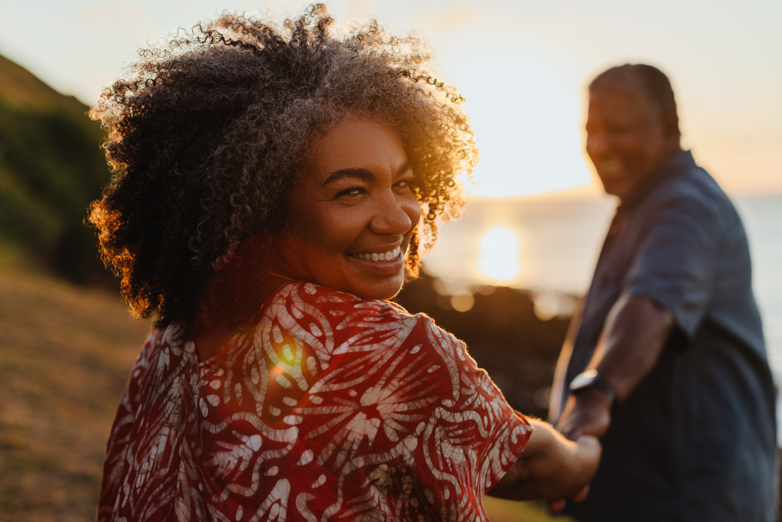 smiling woman with husband at sunset